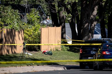 Police and BCA vehicles near a broken piece of fencing at a home at the intersection of Pinewood Ct. and CO RD H2 in Mounds View.