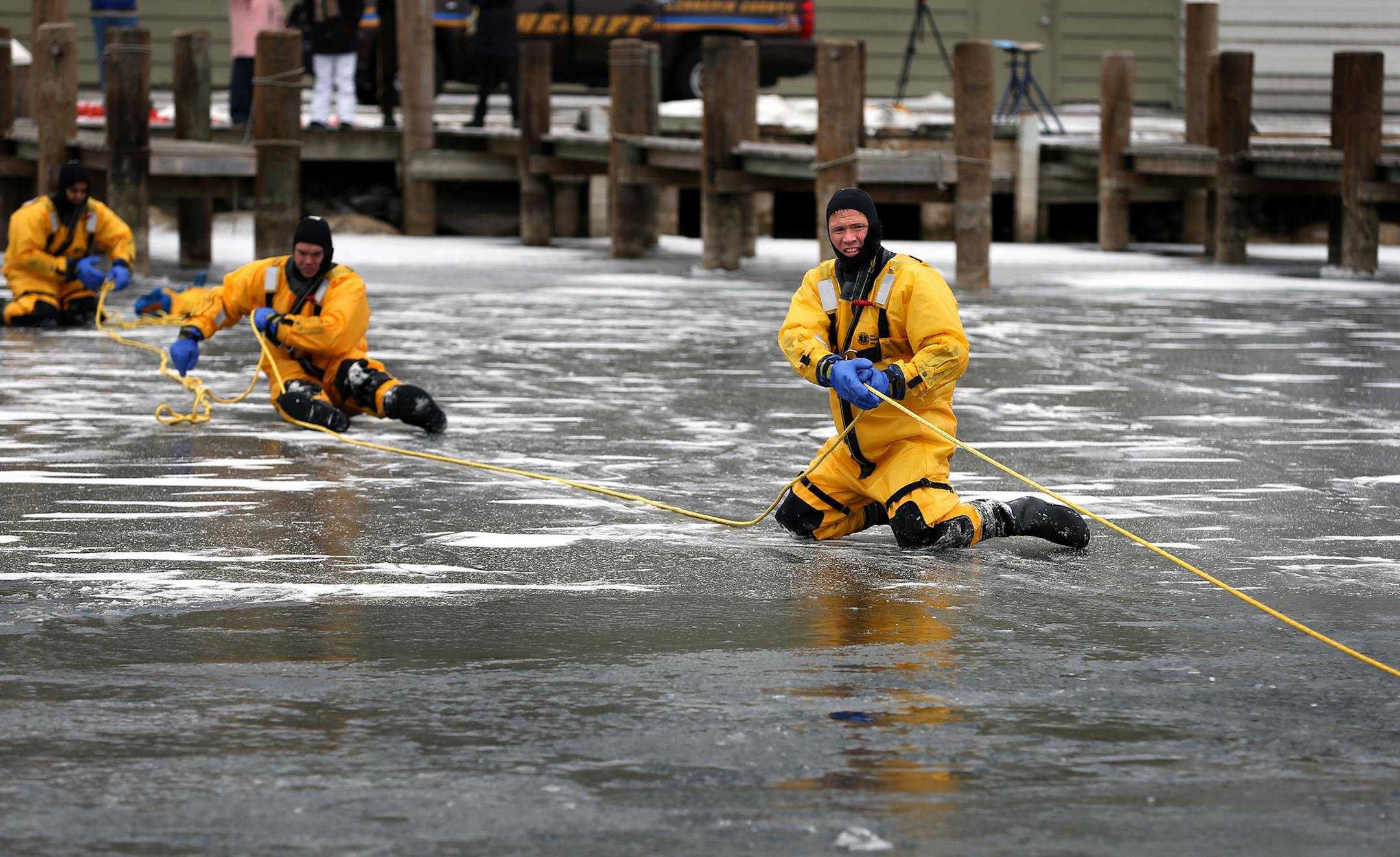Sgt. Kent Vnuk of the Hennepin County Sheriff's office demonstrates an ice/water save at Tonka Bay Marina on Tuesday, November 25, 2014. ] LEILA NAVIDI leila.navidi@startribune.com /