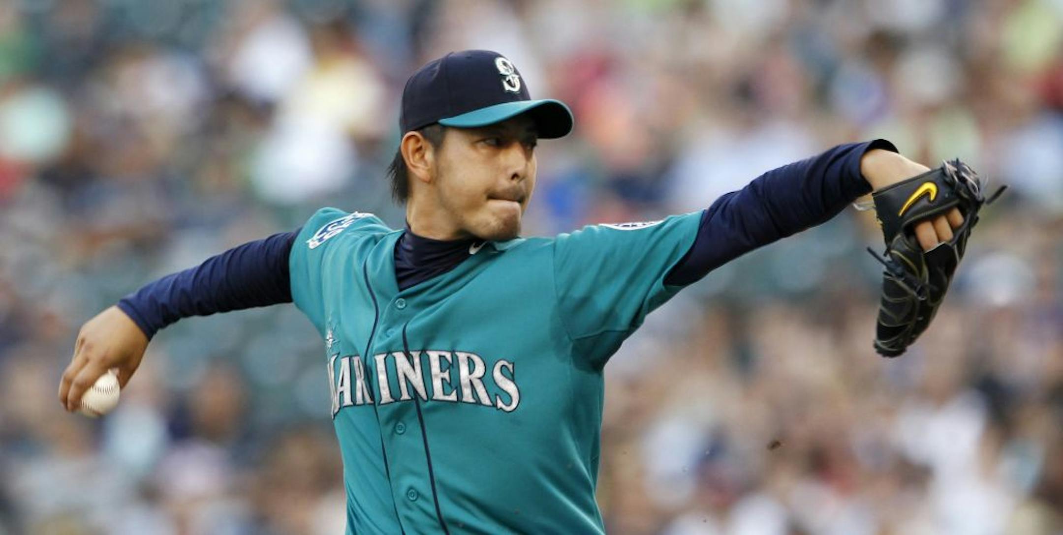 Seattle Mariners starting pitcher Hisashi Iwakuma throws against the Minnesota Twins in the first inning of a baseball game, Friday, Aug. 17, 2012, in Seattle.