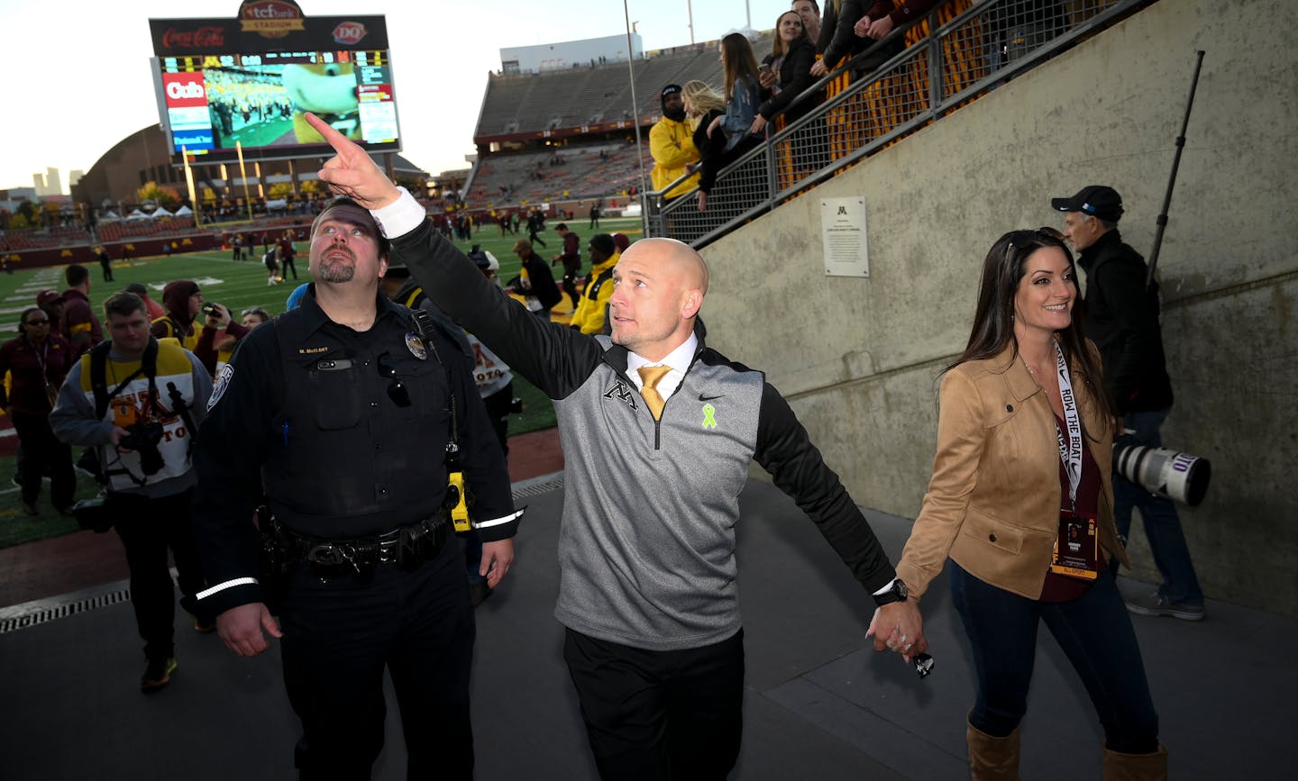 Gophers head coach P.J. Fleck held his wife Heather's hand as he greeted fans after his teams' 52-10 win over Maryland. ] Aaron Lavinsky • aaron.lavinsky@startribune.com The Gophers played the Maryland Terrapins on Saturday, Oct. 26, 2019 at TCF Bank Stadium in Minneapolis, Minn.