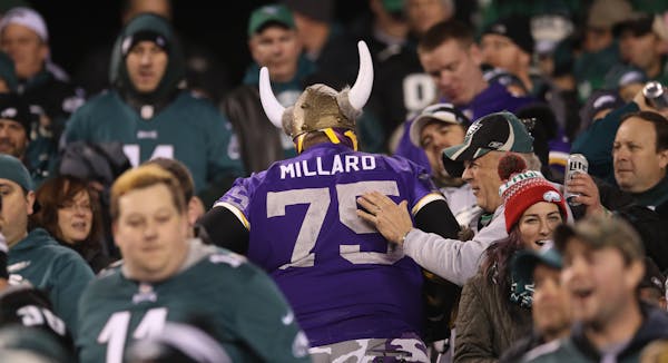 Vikings fan Andrew Grein of Edina got a pat on the back as he left the stadium late in the forth quarter during the NFC Championship game at Lincoln F