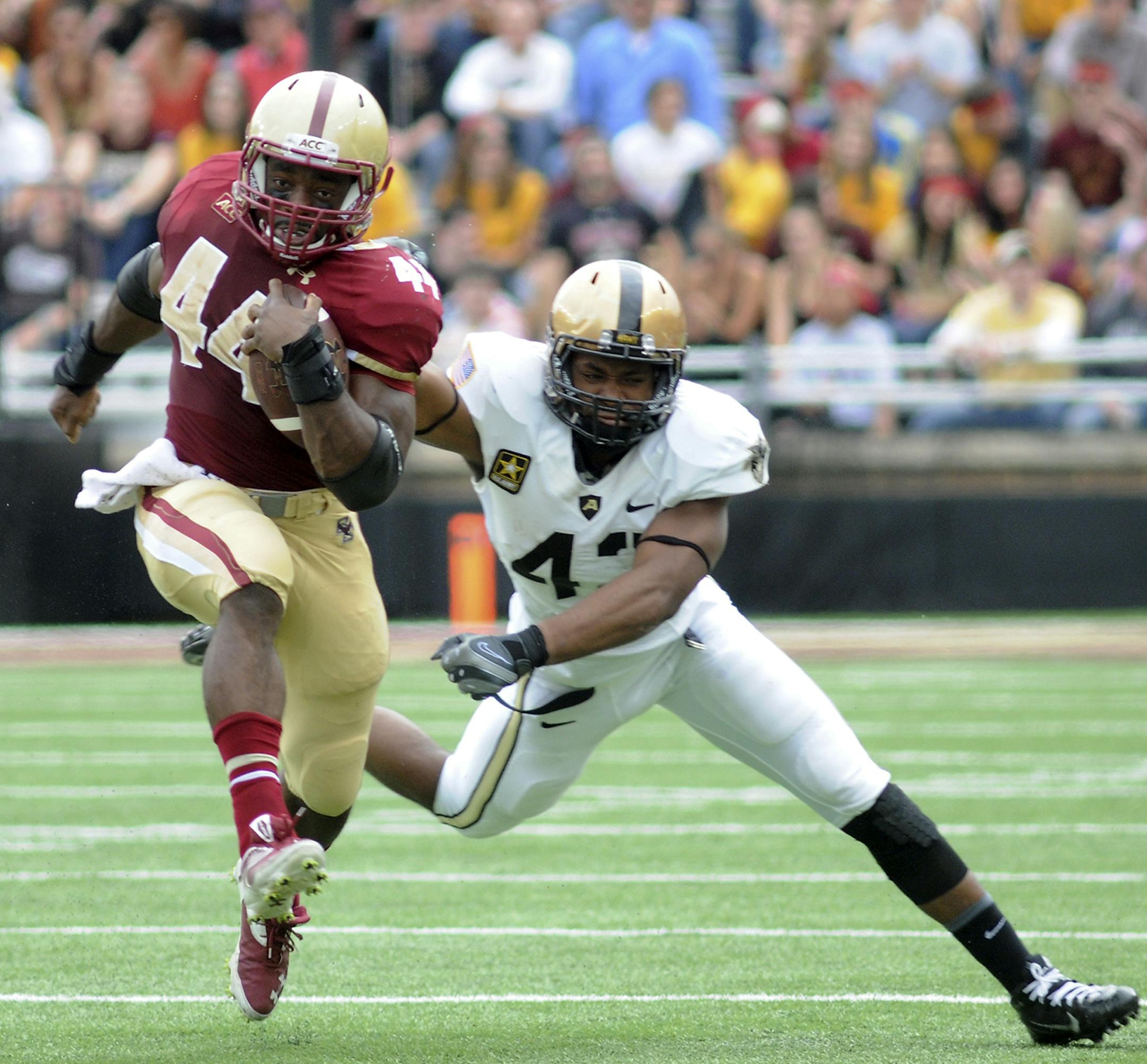 Boston College's Andre Williams runs past Army's Julian Holloway on his way to a touchdown during an NCAA college football game Saturday, Oct. 5, 2013, in Boston. Boston College won 48-27. (AP Photo/The Herald, Faith Ninivaggi) BOSTON GLOBE OUT, METRO BOSTON NEWSPAPER OUT, MAGS OUT, ONLINES OUT