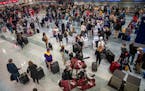 Travelers, including many families, arrived at Terminal 1 to a busy early morning in Bloomington on Sunday, March 20, 2022. 