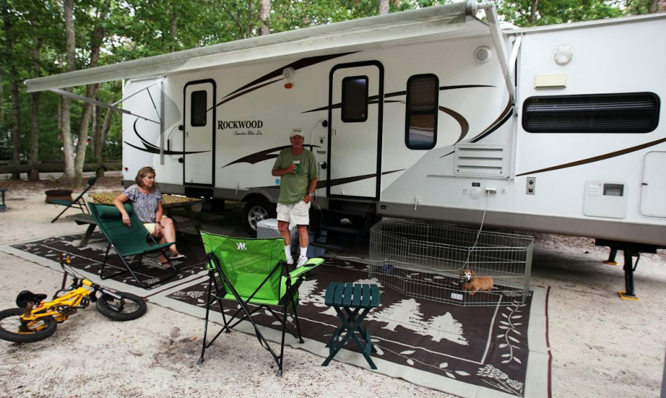 Janet and Carl Reeves, of Millville, NJ, enjoy camping in their recreational vehicle at the Whippoorwill Campground, in Marmora, NJ, Wednesday, Aug. 15, 2012. High gas prices have forced many RV owners to take a camping vacation closer to home.
