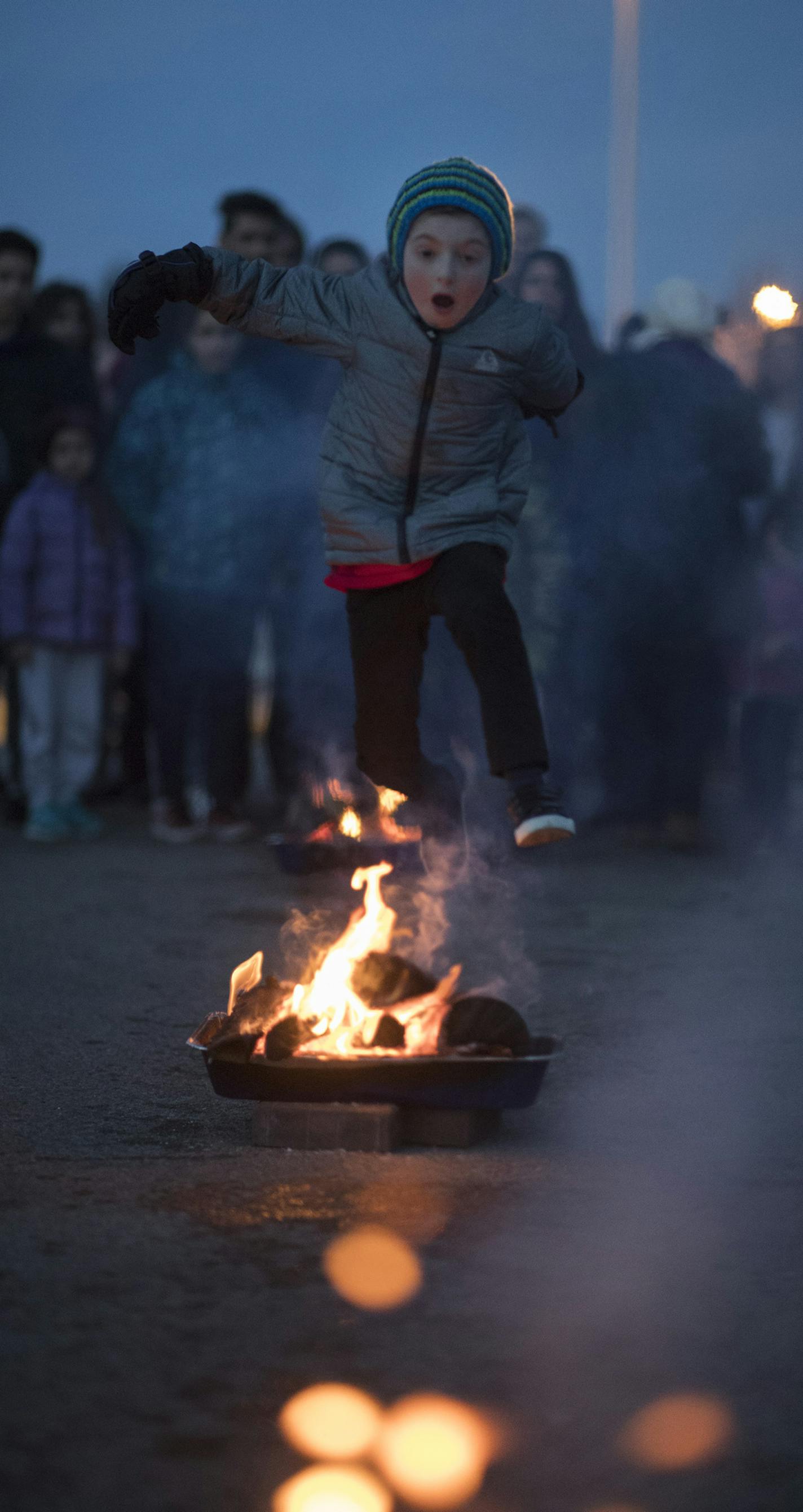 Seven-year-old Arman Newrai jumped over a fire pit during a traditional Iranian New Year's celebration at Cornelia Park in Edina last week.