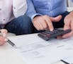 Close-up of mature couple doing finances at home. istock