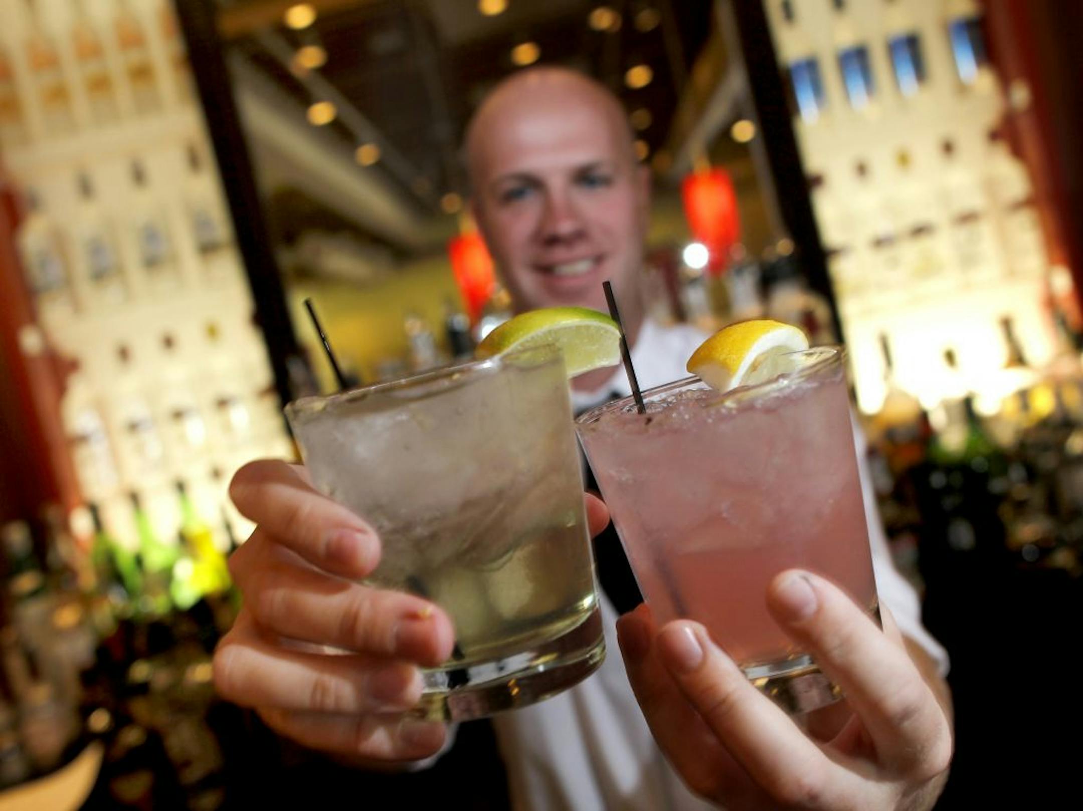 Salut bartender, Mike Karlstad with 2 "happy Hour" specials the Brazilian, left, made with rum and the Fruity Putin, with Vodka. Edina has never had happy hour in its bars and restaurants. After a change in the law, the restaurants at 50th and France will celebrate the very first happy hours ever in this suburb. Some of the bars are celebrating like it's the end of Prohibition with super cheap cocktails [ TOM WALLACE • twallace@startribune.com _ Assignments #20023344A_ May 10, 2012_ SLUG: night0