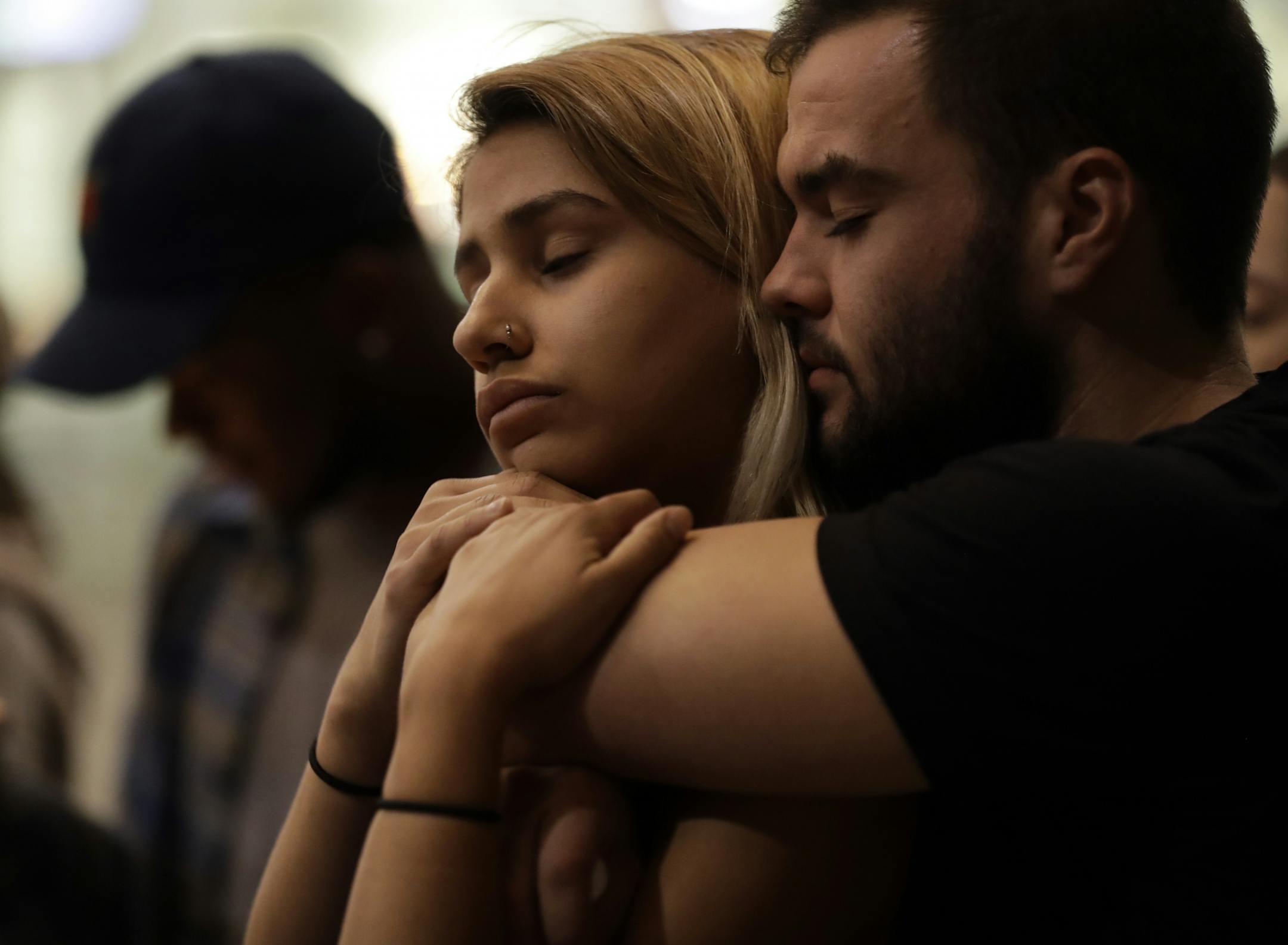 University of Nevada Las Vegas students Raymond Lloyd, right, and Karla Rodriguez take part in a vigil Monday, Oct. 2, 2017, in Las Vegas.