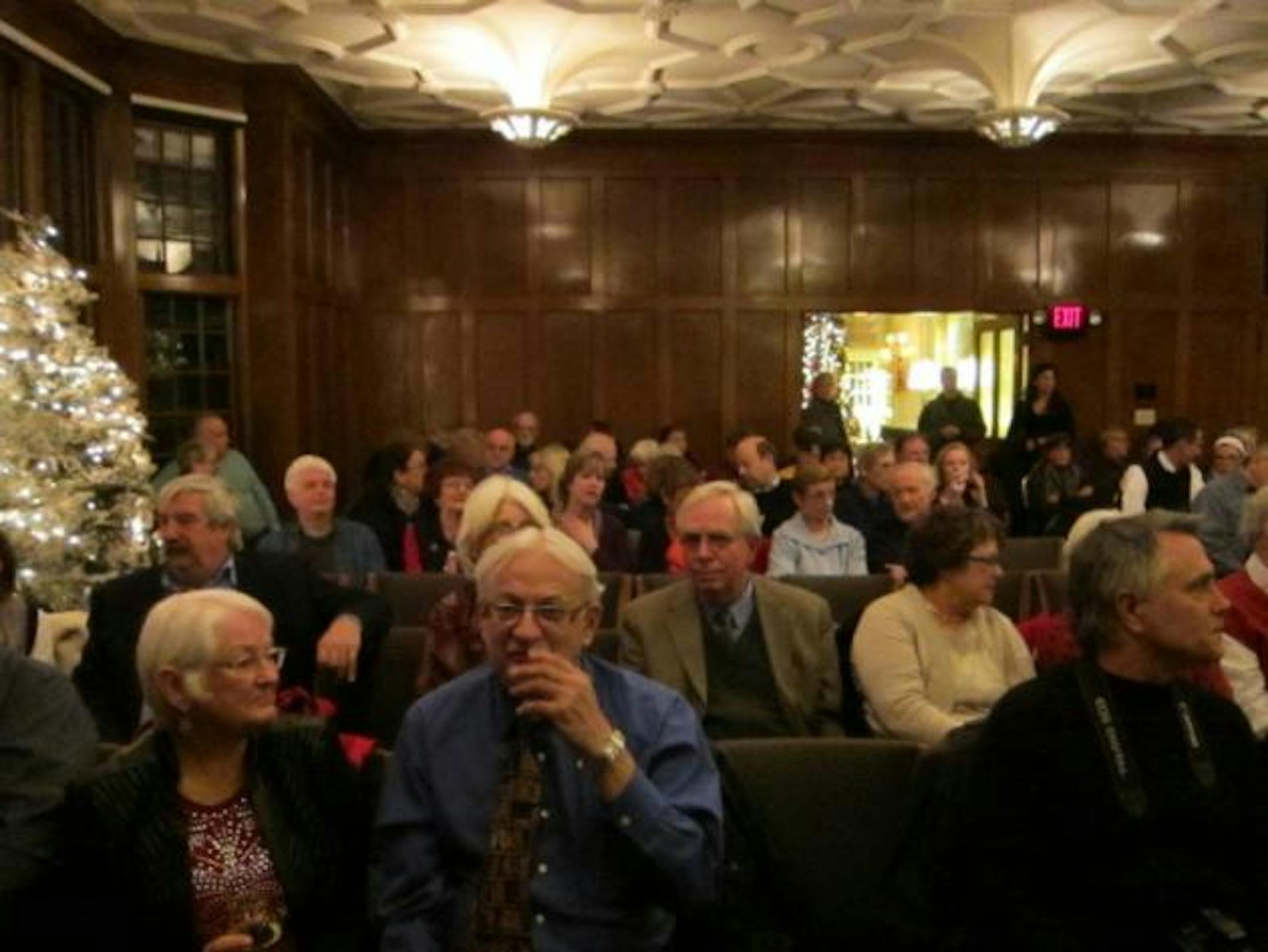 Inside, the room filled up. Someone brought in more chairs, and more.