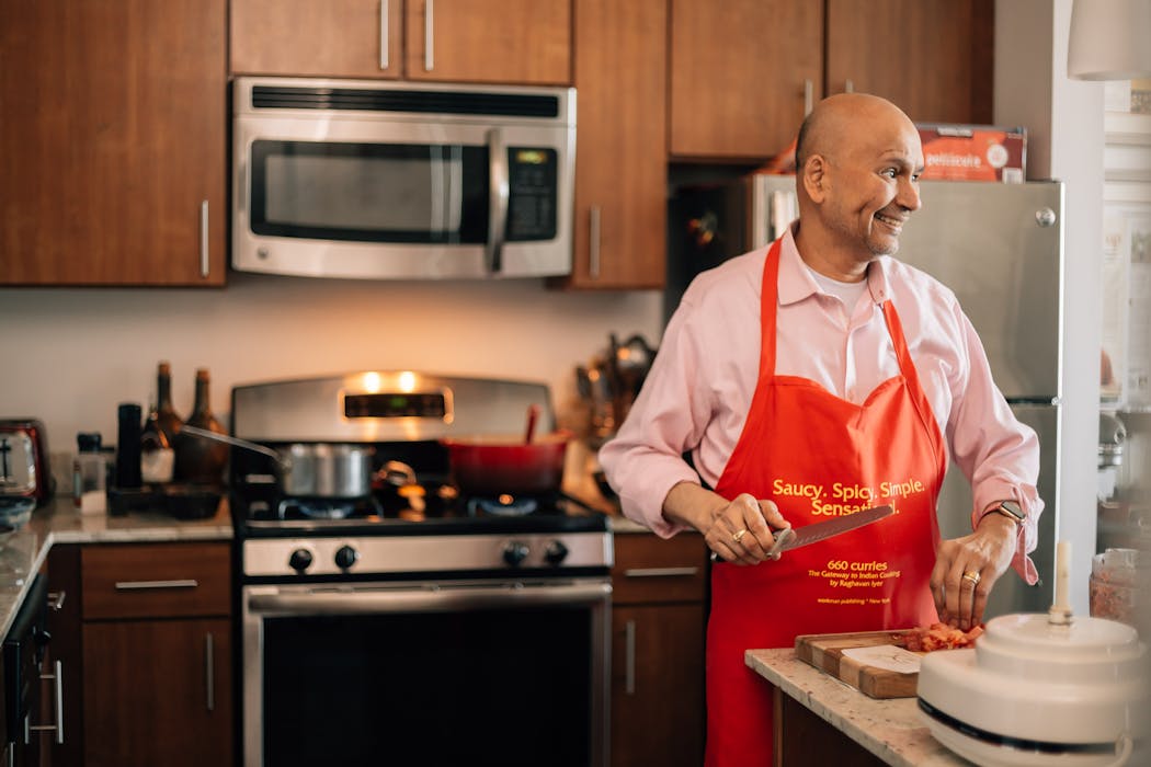 Raghavan Iyer prepares a lunch of vegetable rice and kidney beans at his home in Minneapolis, He says his latest cookbook, “On the Curry Trail: Chasing the Flavor That Seduced the World in 50 Recipes,” will be his last.