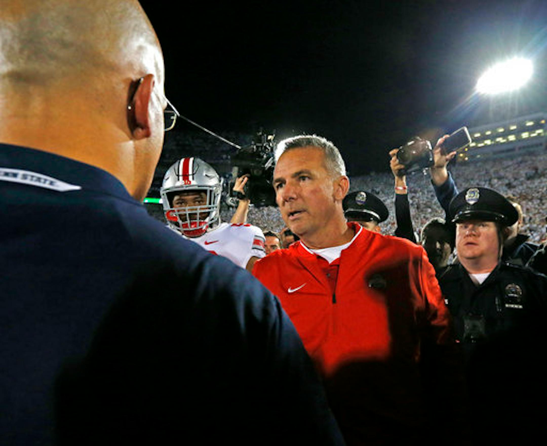 Ohio State head coach Urban Meyer, right, shakes hands with Penn State head coach James Franklin, left, after an NCAA college football game in State College, Pa., Saturday, Sept. 29, 2018. Ohio State won 27-26. (AP Photo/Chris Knight)