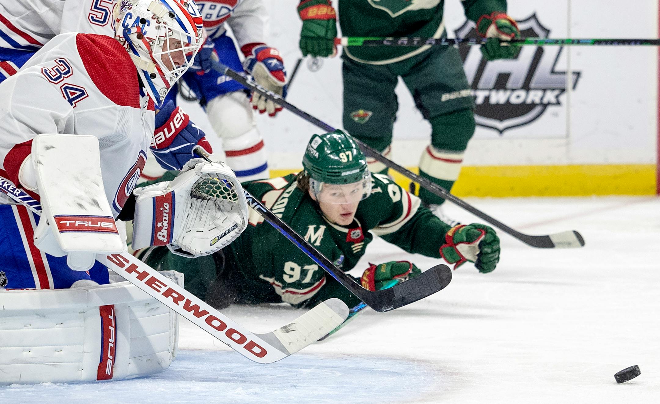 Montreal Canadiens goalie Jake Allen (34) and Kirill Kaprizov (97) of the Minnesota Wild both go after the puck in the first period.