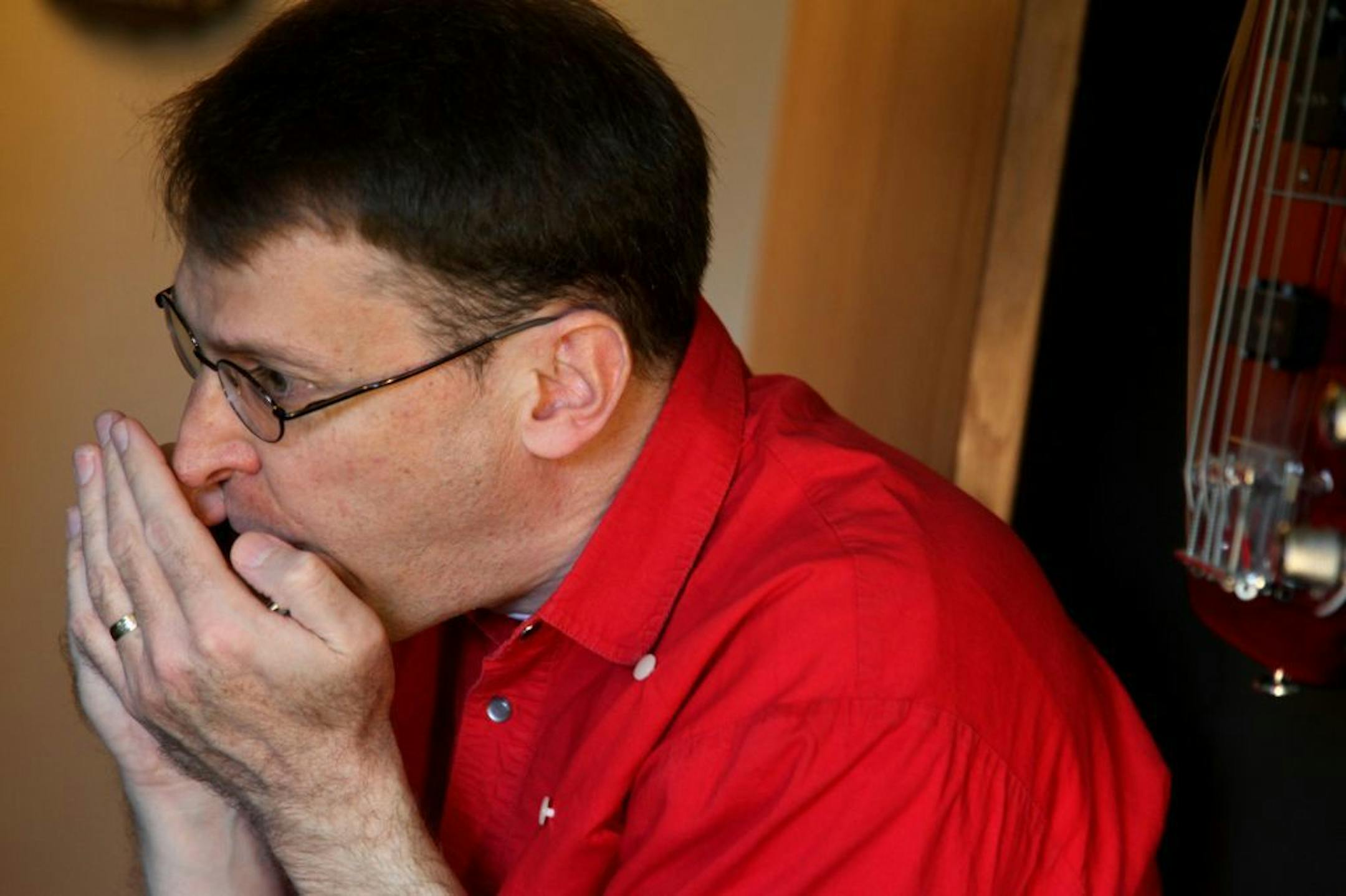 The Rev. John Stiles played the harmonica as he and two others worked on producing a music project known as "We are the Children, Some Light from Darkness" at the Kendall Johnson Studio in Oakdale, MN, Monday, April 16, 2012. .(ELIZABETH FLORES/STAR TRIBUNE) ELIZABETH FLORES � eflores@startribune.com