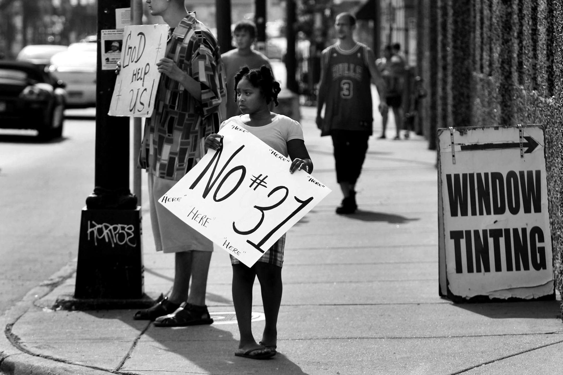 Curtina Wilson, 9, has a hero in her dad KG Wilson. The elder Wilson heads Hope Ministries and has teamed up with Charez Jones Foundation - named after 14 year-old-Charez Jones who was was killed in 2007 during random gun violence in Minneapolis. Like her dad, Curtina wants an end to the killing. Together, they often visit city homicide sites to honor the dead and remind passing motorists and pedestrians of deaths too soon and unnecessary, like the one on July 28 in the 2900 block of 5th Ave. S.