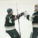 Wild left wing Chris Porter (7) congratulated Wild goalie Devan Dubnyk (40) on stopping a season high 38 shots on the way to the team's third win in a