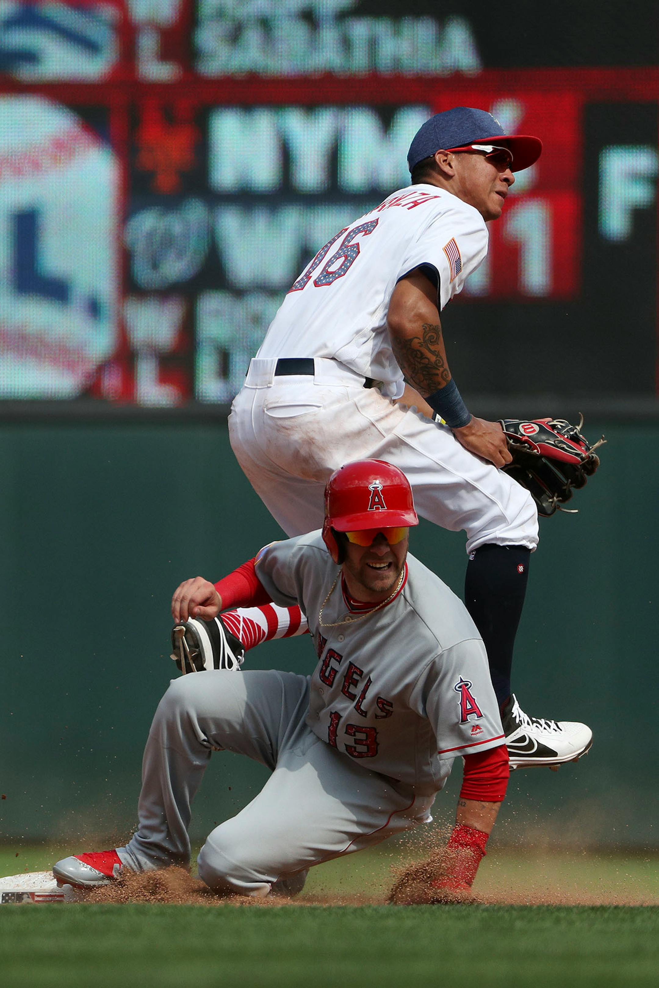 Los Angeles Angels left fielder Nick Franklin (13) collided with Minnesota Twins shortstop Ehire Adrianza (16) at second after he threw to first to get the out in the ninth inning.