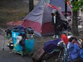City of Minneapolis workers and officials cleared out a a homeless encampment in a median near the intersection of Franklin and Cedar avenues Tuesday 