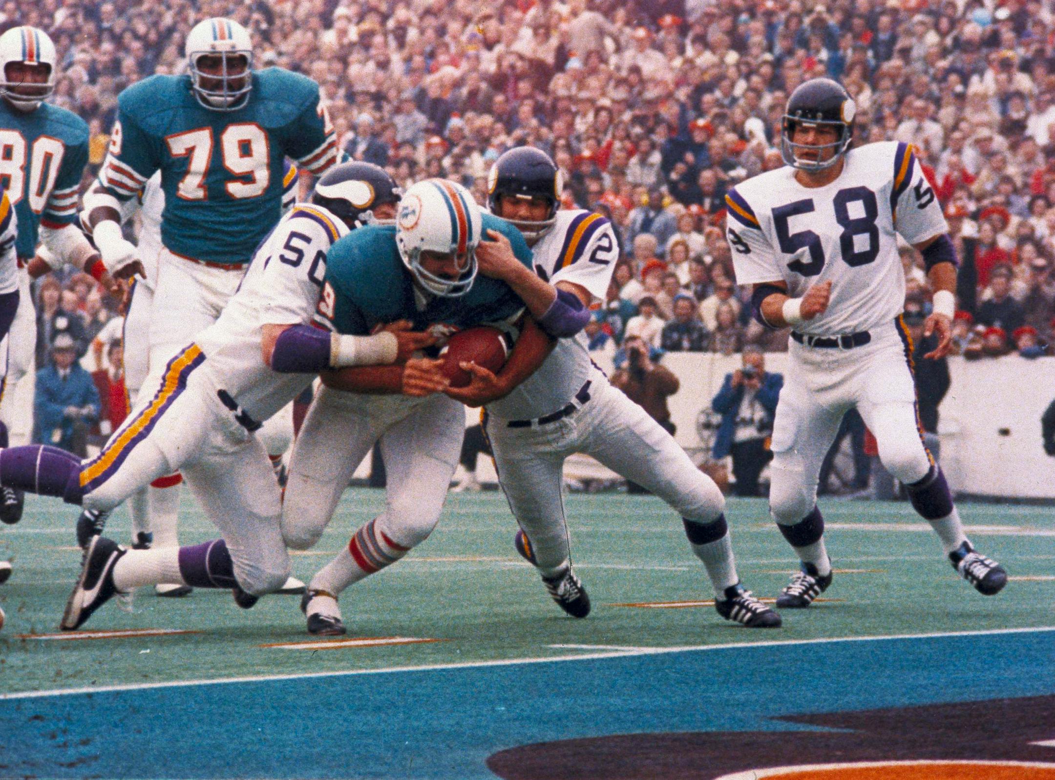 Miami Dolphins Larry Csonka racing through the Minnesota Vikings line. Miami defeated the Vikings 14-7 to win Super Bowl VIII, at the Los Angeles Coliseum, January 14, 1974 (AP Photo)