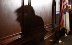 The shadow of Republican presidential candidate Donald Trump is cast against the wall as he speaks to members of the City Club of Chicago, Monday, Jun
