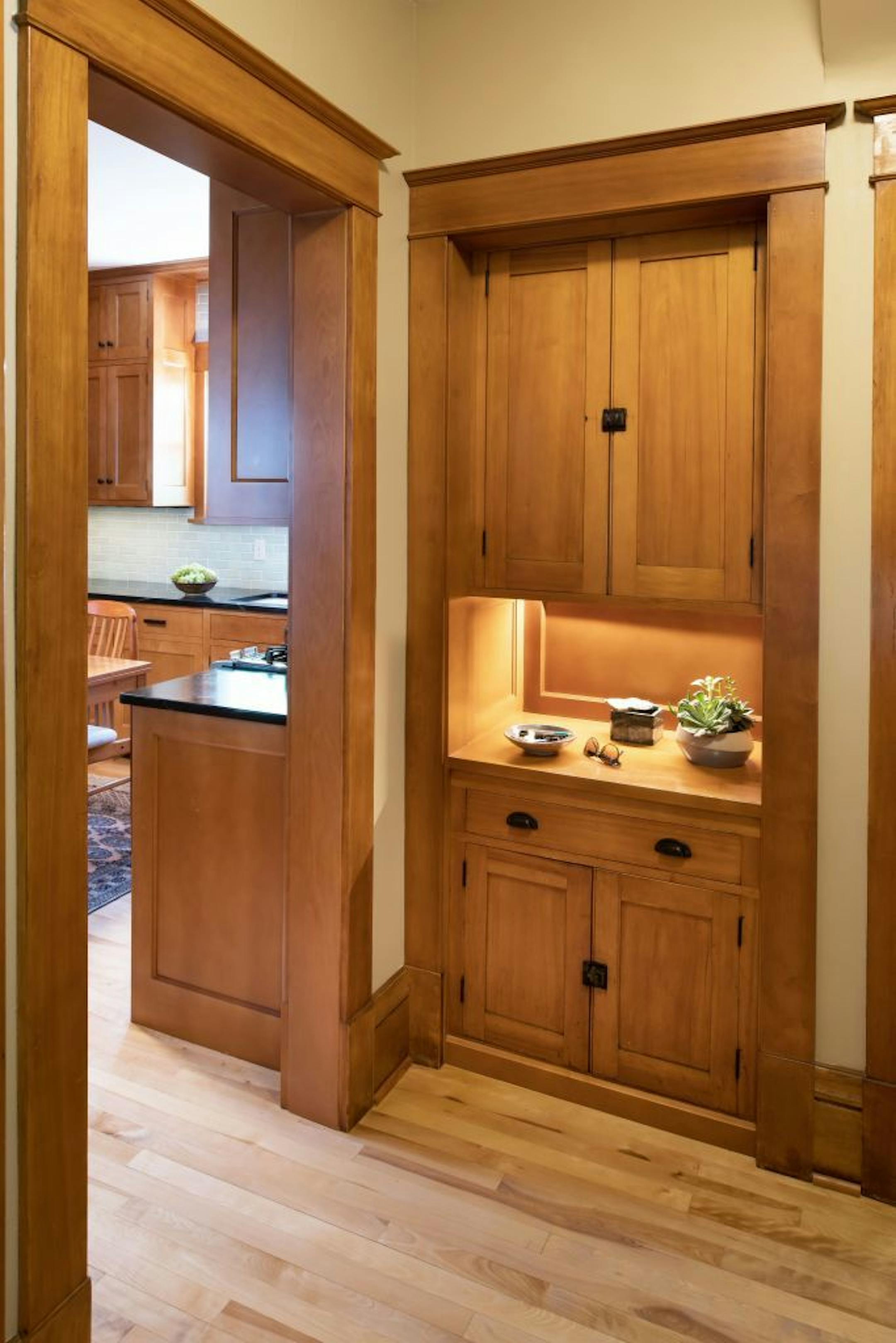 Cabinets from the wall that was removed were repurposed to create a drop zone in the space where the maid's staircase used to be.