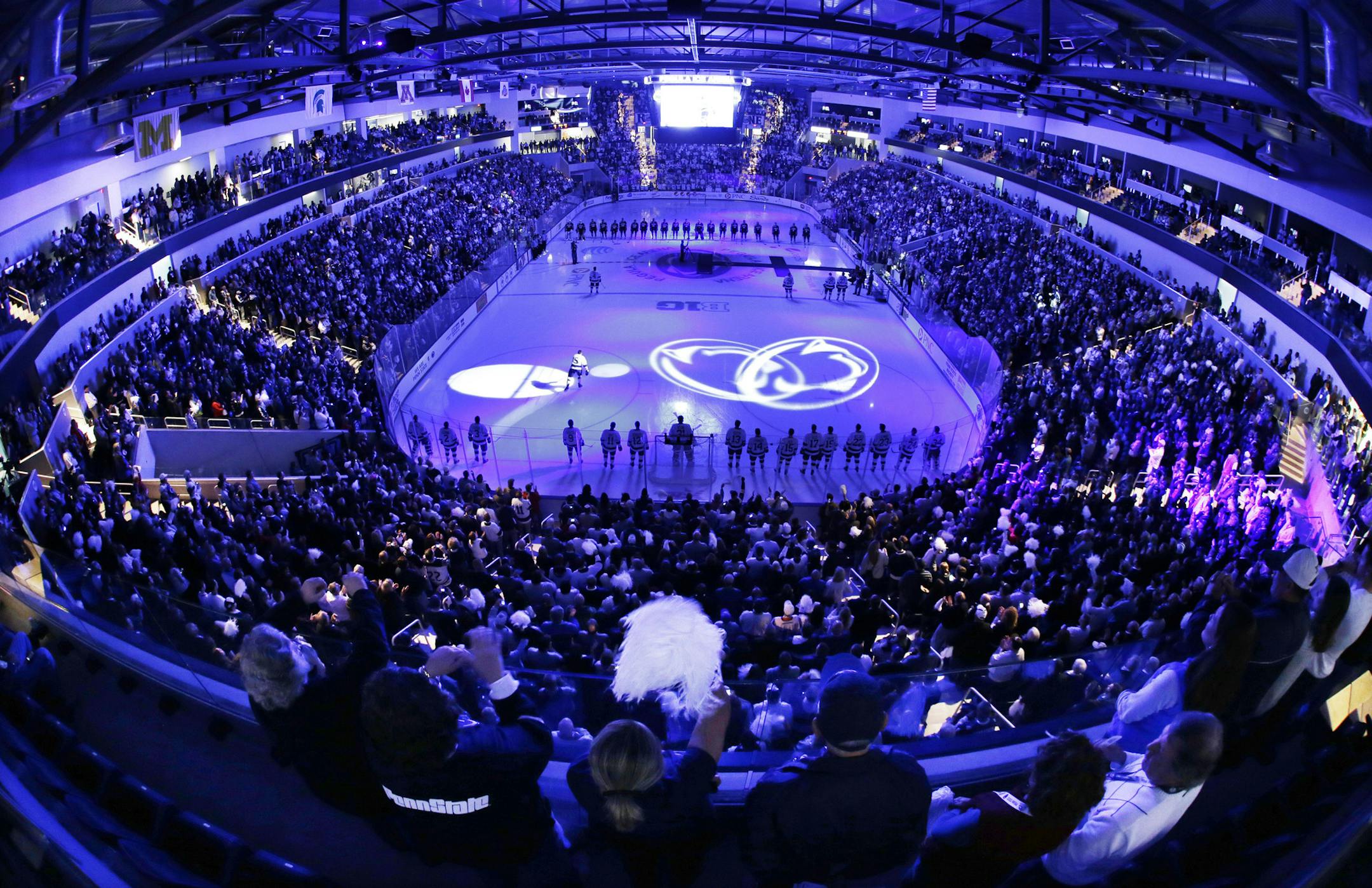 In this photo taken with a fishheye lens, the Penn State men's college hockey team is introduced before a game against Army at the Pegula Ice Arena in State College, Pa., Friday, Oct. 11, 2013. The game is the first in the new arena. (AP Photo/Gene J. Puskar) ORG XMIT: PAGP106
