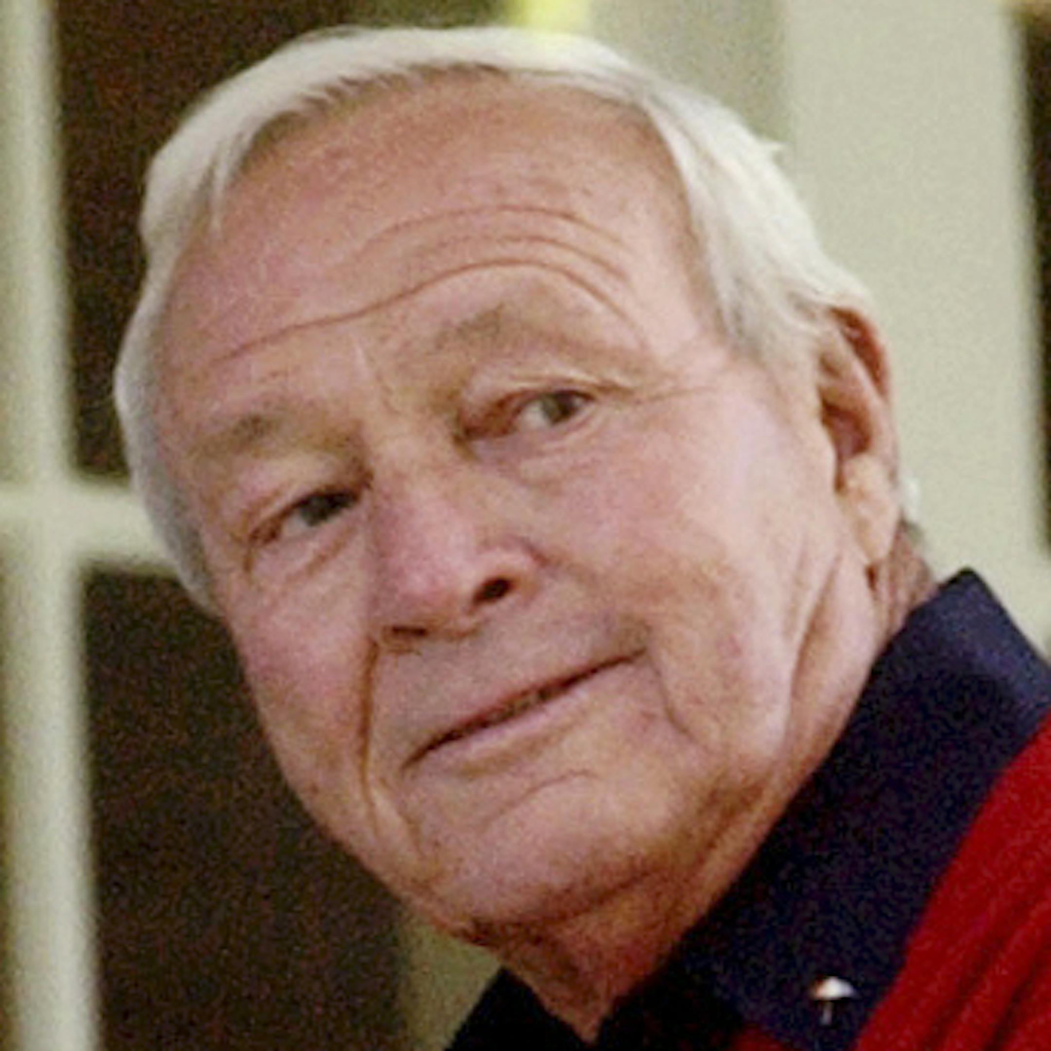FILE - This 2004 file photo shows former Masters champion Arnold Palmer as he sits on clubhouse railing at the Augusta National Golf Club in Augusta, Ga. In his first year as PGA Tour commissioner, Jay Monahan said his top priority was to make Arnold Palmer proud. He has seen enough evidence halfway through the year to believe the tour is on the right track. (AP Photo/David J. Phillip, File)
