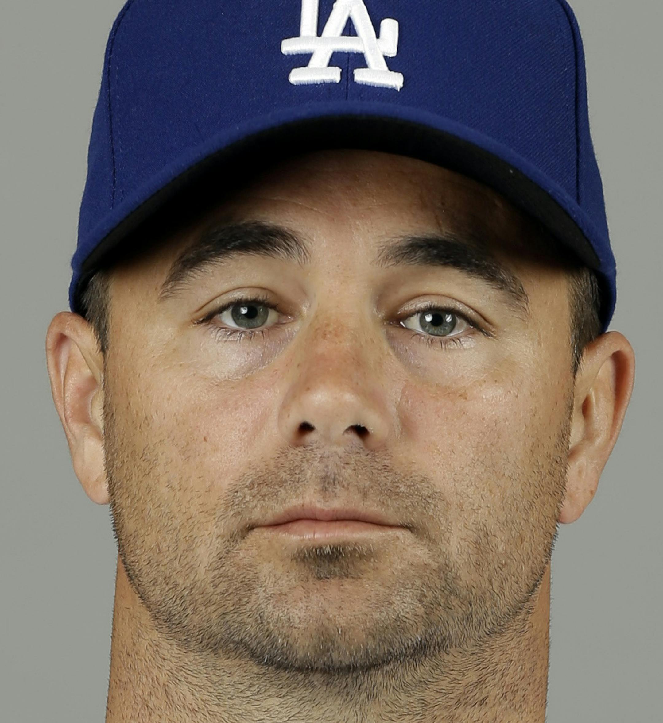 FILE - This 2013 file photo shows Los Angeles Dodgers pitcher Ted Lilly. The former major league baseball player has been charged in California with three felonies related to insurance fraud, the San Luis Obispo Tribune reported, Friday, Jan. 23, 2015. (AP Photo/Paul Sancya, File)