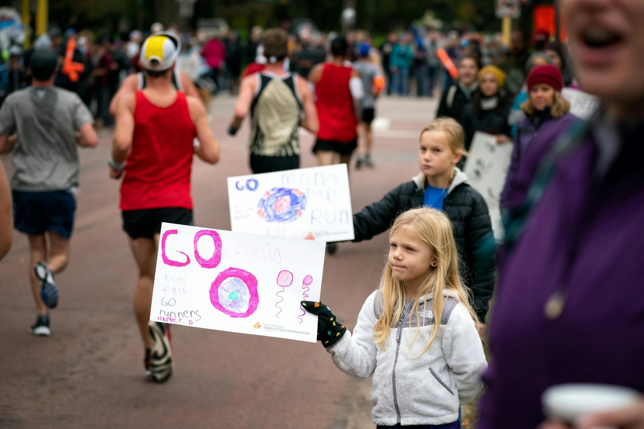 Harper Dubas, 6, and her sister Presley Dubas, 8, waited patiently for their mom Kelia along Minnehaha Ave near the 11 mile mark of the Twin Cities Marathon.