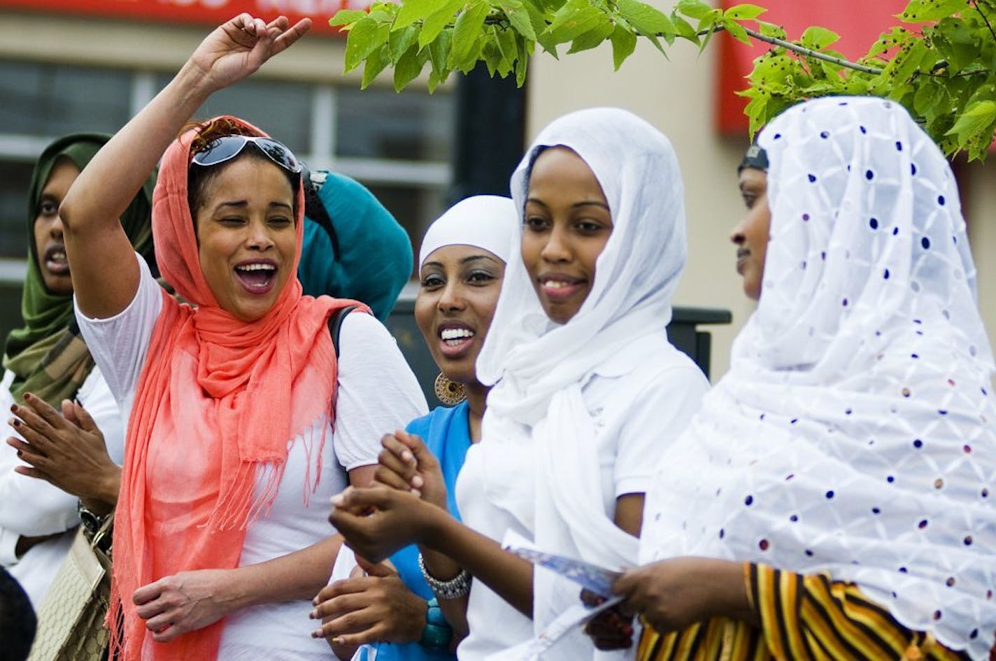 (left to right) Shukri Awale, Ayan Dhore, Nimo Guled and Halimo Guled all from Mogadishu, Somalia cheer and sing along to Somalian music. Hundreds from the Minneapolis Somalian community gathered on Lake Street on Saturday to celebrate Somali Independence Day which is on July 1.