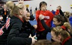 Lakeville North team members are overcome with joy after learning they had won the Minnesota State High School 2A gymnastics team championship Friday,