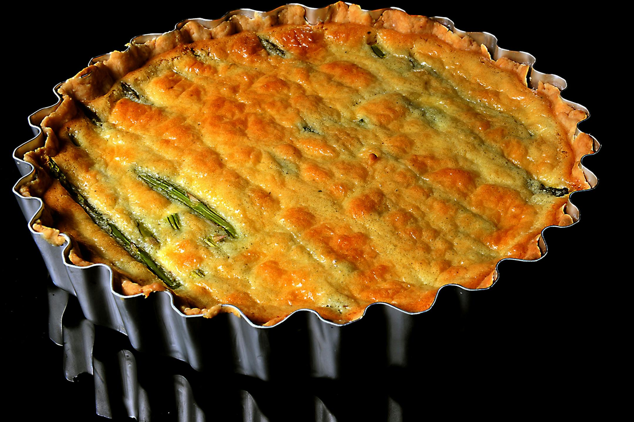 Asparagus spears are laid out side by side in this tart made with goat cheese. (Nate Guidry/Pittsburgh Post-Gazette/TNS)