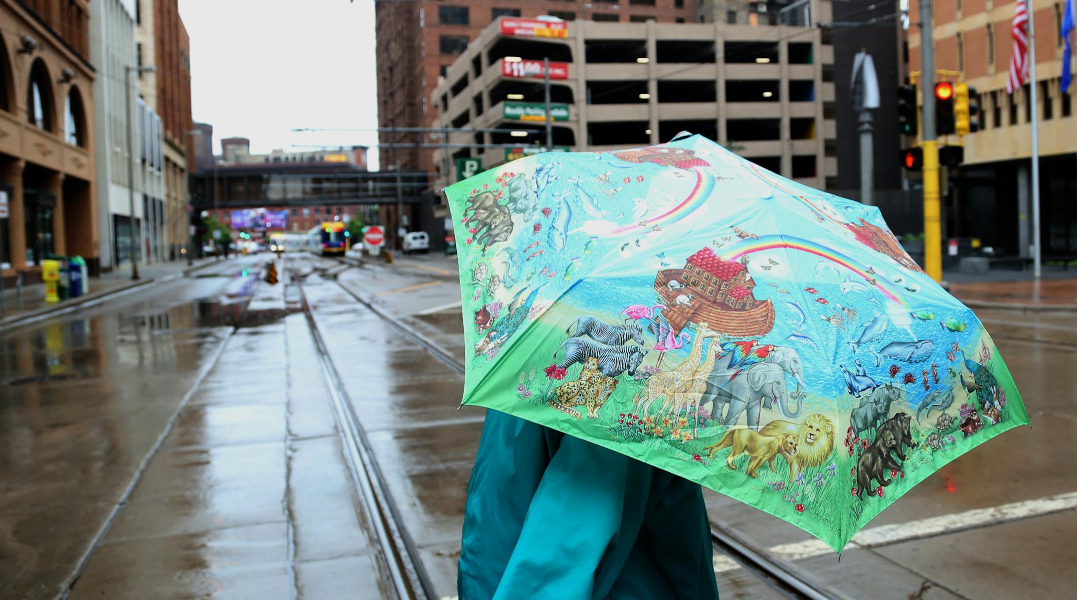 LaVonne Landsverk walked across fifth street streeton the Nicollet Mall under her colorful umbrella. ] (KYNDELL HARKNESS/STAR TRIBUNE) kyndell.harkness@startribune.com Weather in downtown Minneapolis , Min., Thursday, June 11, 2015.