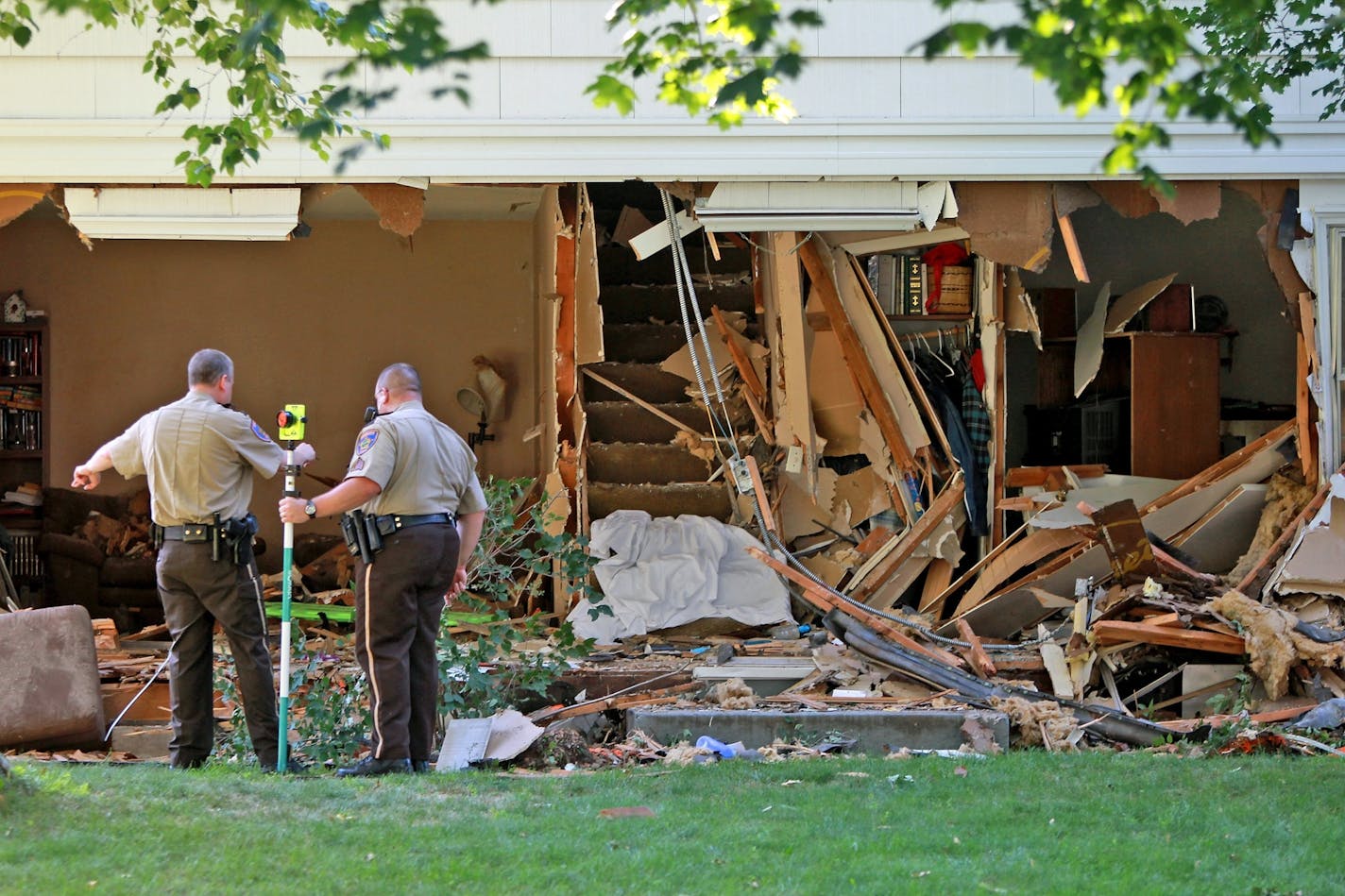 Anoka County Sheriff investigated the scene where a the driver of a stolen SUV plowed into a home on the 10400 block of Terrace Road in Blaine.