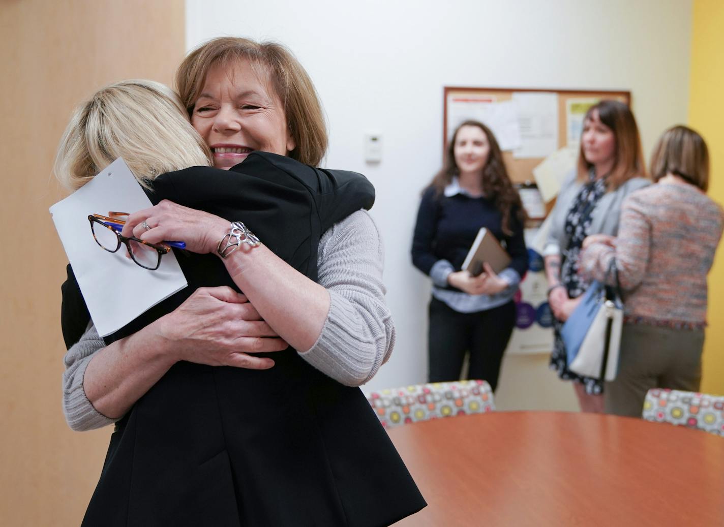 Sen. Tina Smith toured the Richfield Planned Parenthood clinic Friday, hugging CEO Sarah Stoez. Minnesota is challenging the new rules.