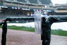 A water collects in a rain gauge at Target Field as rain forced the postponement of a game between the Twins and the Royals on Saturday. The game will