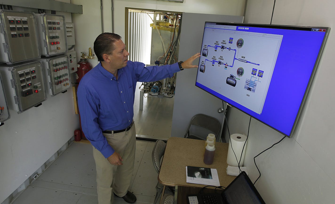 SarTec/EverCat Fuels' Clayton McNeff showed how a portable biodiesel production unit works Friday, August 2, 2013 in Isanti, MN. The company plans to take it to farms, agricultural businesses and co-ops to process natural oil wastes, soybean oil and other lipids into biodiesel. (ELIZABETH FLORES/STAR TRIBUNE) ELIZABETH FLORES &#x2022; eflores@startribune.com