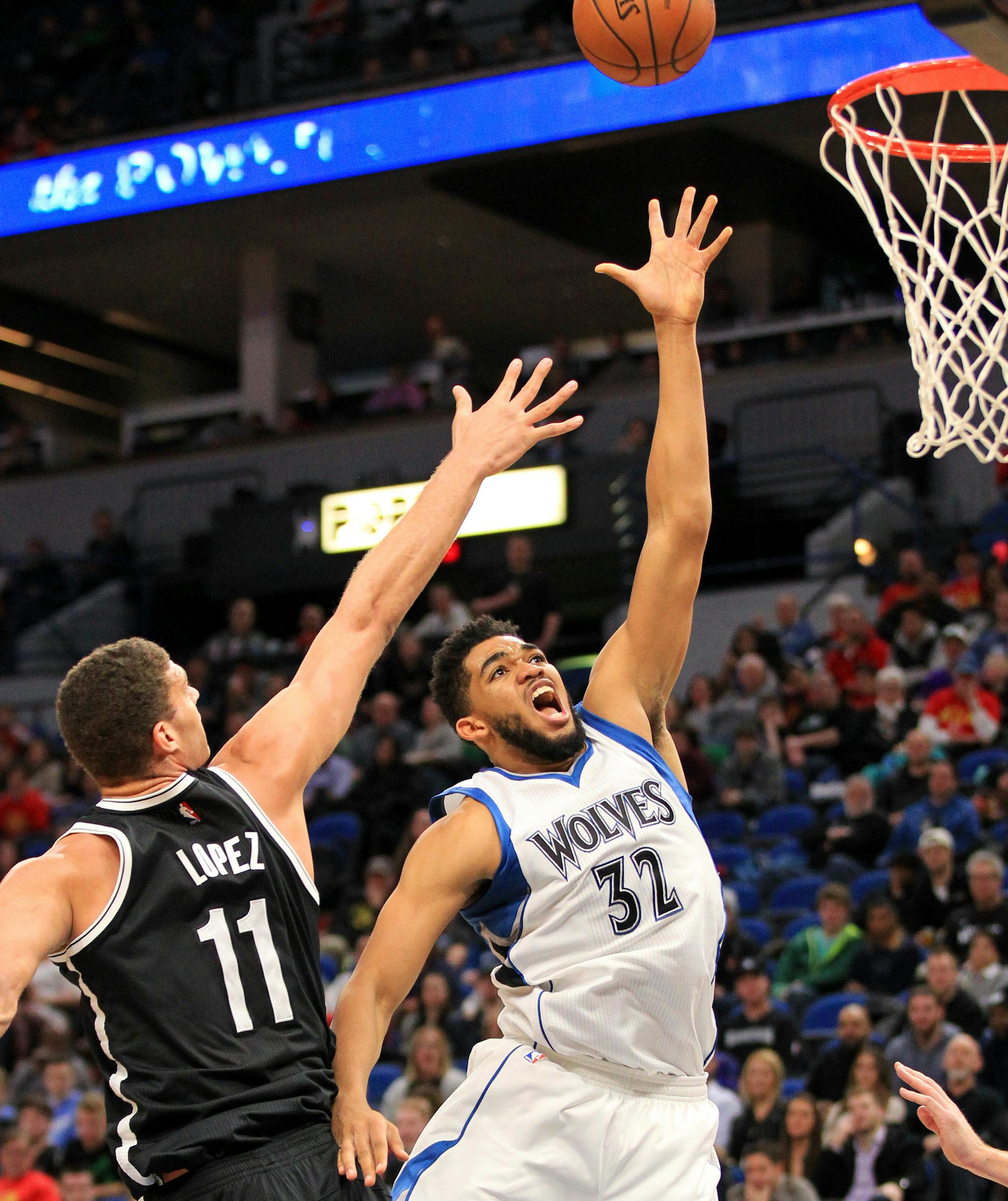 Minnesota Timberwolves center Karl-Anthony Towns (32) shoots next to Brooklyn Nets center Brook Lopez (11) during the third quarter of an NBA basketball in Minneapolis, Saturday, Jan. 28, 2017. The Timberwolves defeated the Nets 129-109. (AP Photo/Andy Clayton-King)