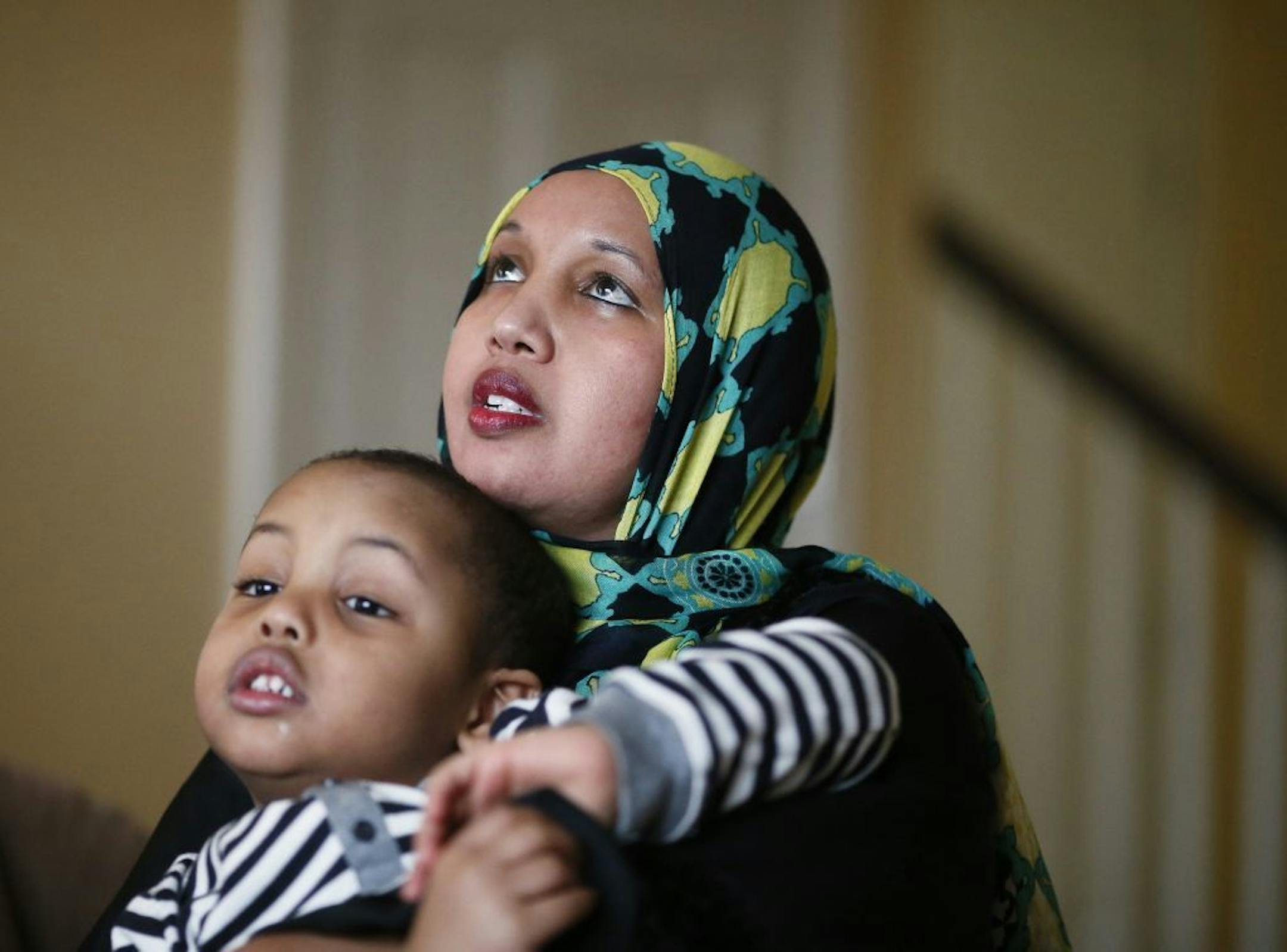 Holding her 4-year-old autistic son Anas Hassan, Marian Ahmed talked about her struggles to maintain rental housing Wednesday December 24, 2014 Savage, MN.