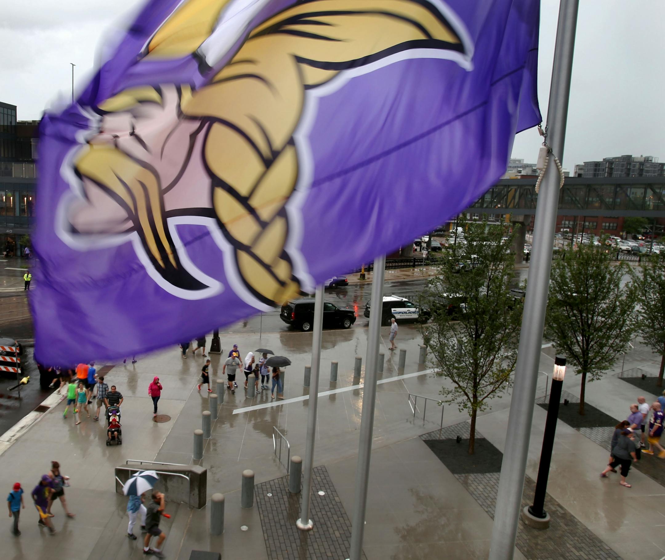 A largemVikings flag blows in the wind during a storm at the public opening at the U.S. Bank Stadium as the current radar of a fast moving storm was visible Saturday, July 23, 2016, in Minneapolis, MN.