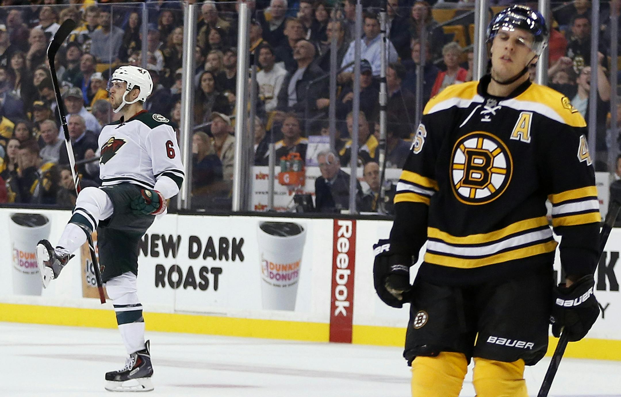 Boston Bruins center David Krejci (46), of the Czech Republic, reacts as Minnesota Wild defenseman Marco Scandella (6) celebrates his go-ahead goal in the third period of an NHL hockey game in Boston, Tuesday, Oct. 28, 2014. The Wild won 4-3. (AP Photo/Michael Dwyer)