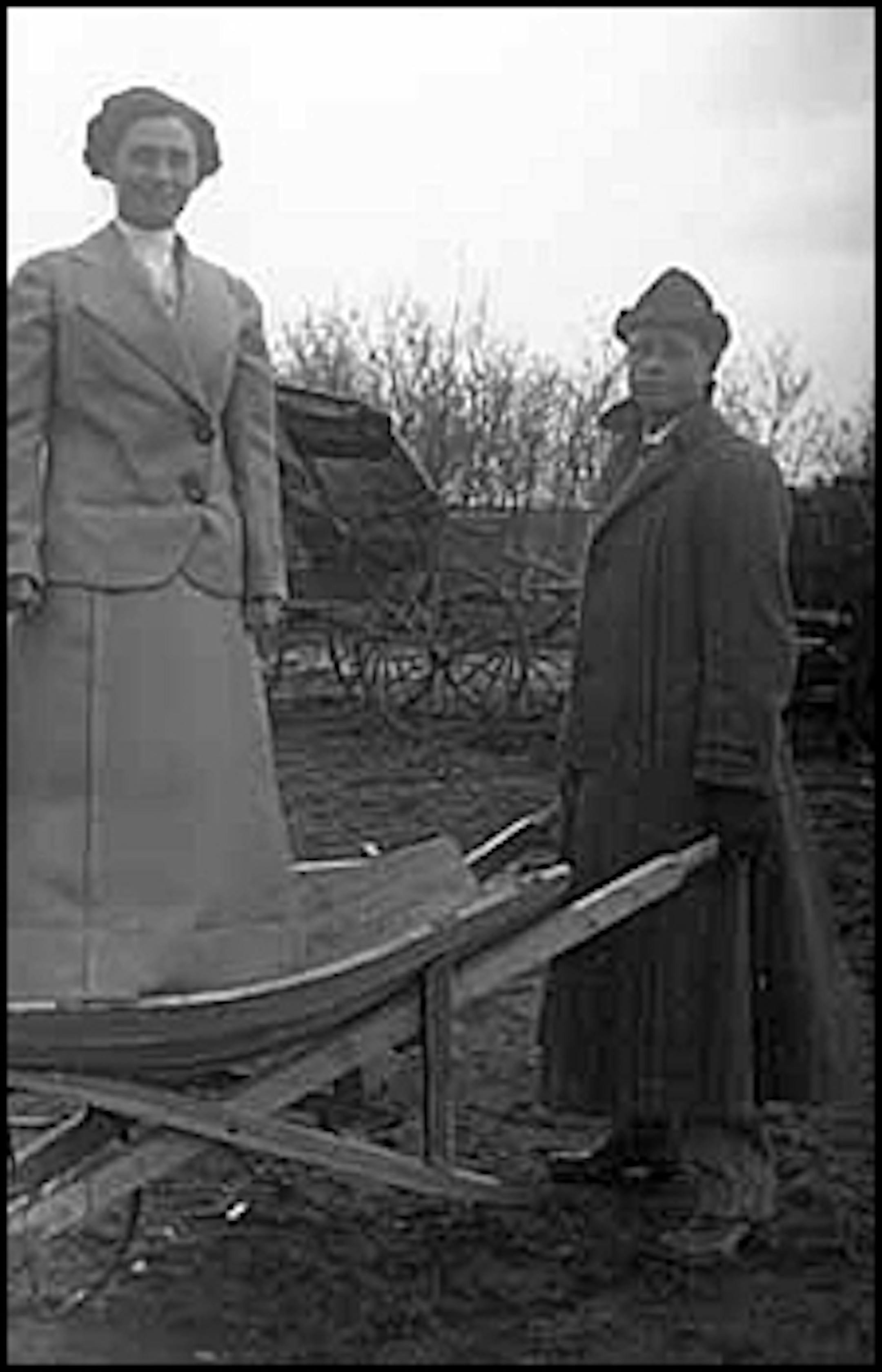 Olai Homme and his wife Josephine, who is standing in a wheelbarrow, near Echo, ca. 1915
