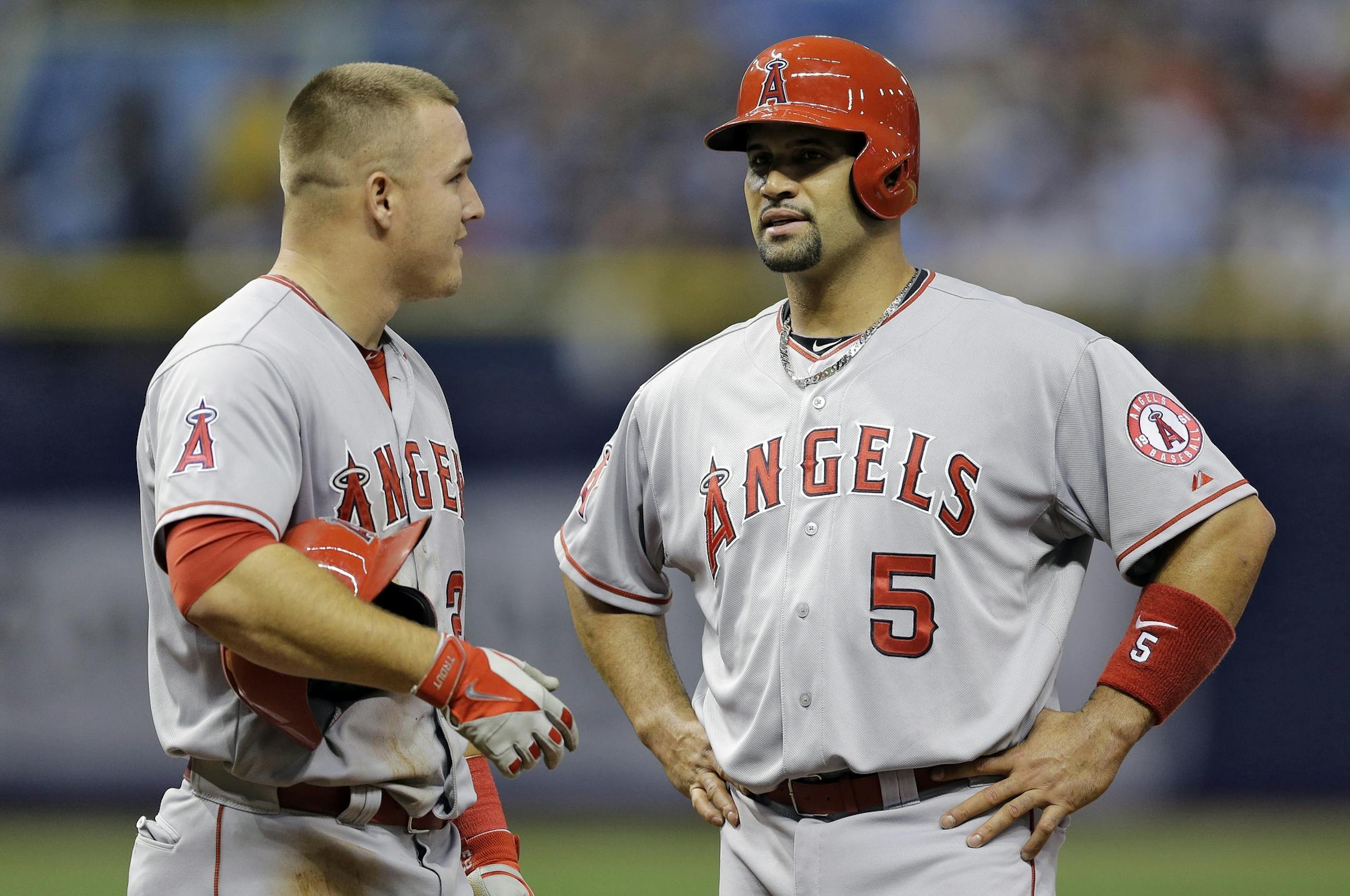 Los Angeles Angels' Mike Trout, left, and Albert Pujols during the sixth inning of a baseball game against the Tampa Bay Rays Tuesday, June 9, 2015, in St. Petersburg, Fla. (AP Photo/Chris O'Meara) ORG XMIT: OTKCO106