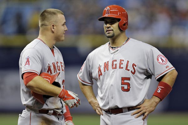 Los Angeles Angels' Mike Trout, left, and Albert Pujols during the sixth inning of a baseball game against the Tampa Bay Rays Tuesday, June 9, 2015, i
