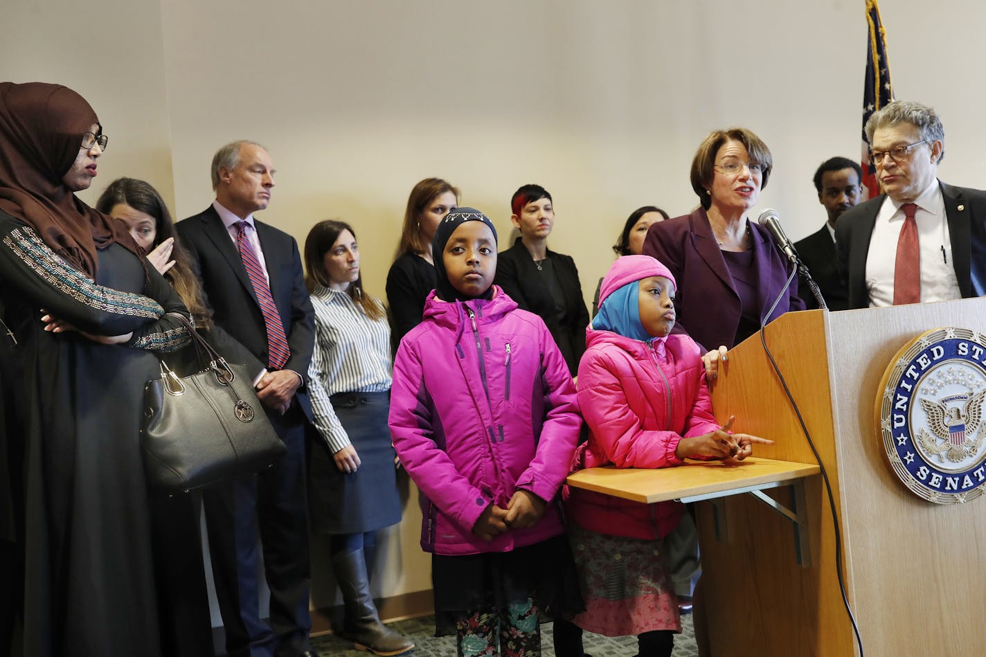 Samira Dahir left ,mother of the two girls left to right Muwahib Abdi 8, and Mumtaz Abdi listened as Minnesota senators Amy Klobuchar and Al Franken gave a press conference after meeting with Minnesotans affected by President Trump&#xed;s immigration orders on refugees Sunday January 29, 2017 in St. Paul, MN.