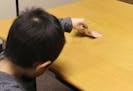 In this Jan. 27, 2016 photo provided by the University of Toronto, a child peeks at a hidden card when an adult leaves the room and later lies about n