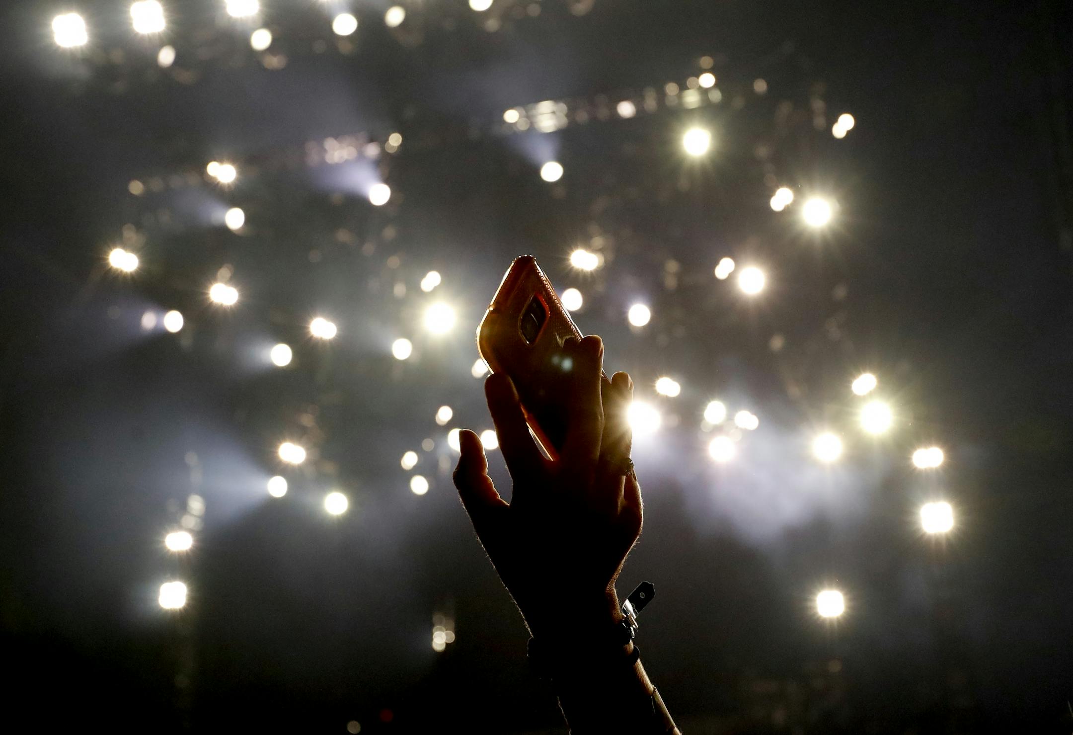 A fan held up cell photo as she waited for Luke Bryan to perform at US Bank Stadium.
