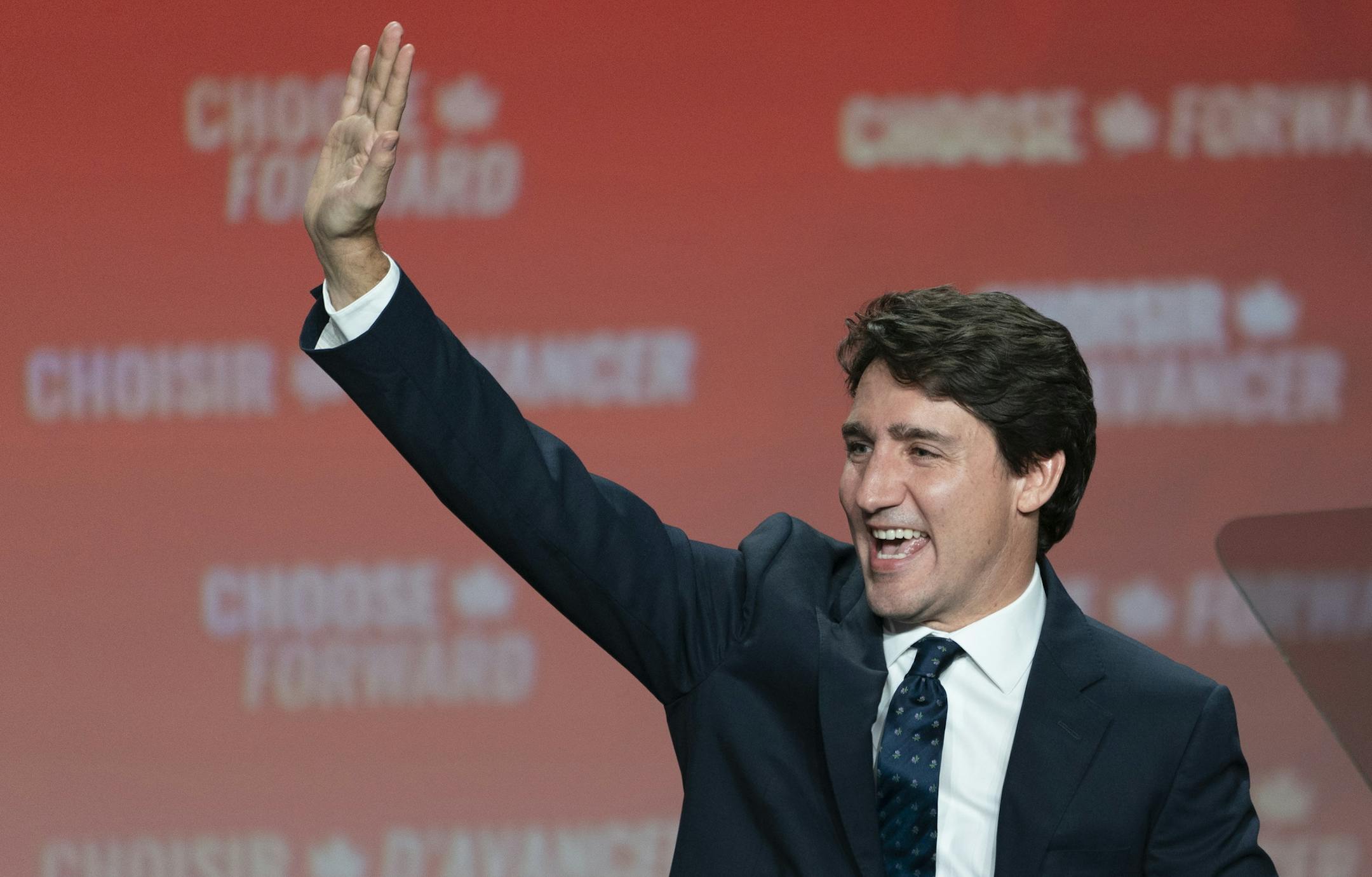 Liberal Leader Justin Trudeau waves to the crowd as he takes the stage in Montreal, on Tuesday, Oct. 22, 2019. (Paul Chiasson/The Canadian Press via AP)