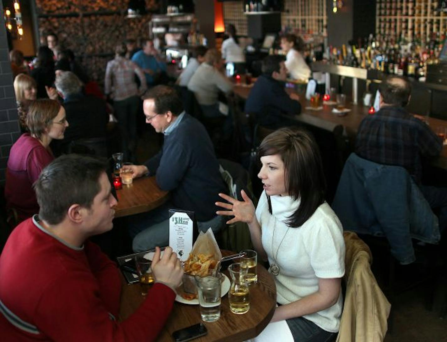 Jim Smith and LeeAnn Schirmer chat over drinks and a snack in the lively bar at Il Gatto.