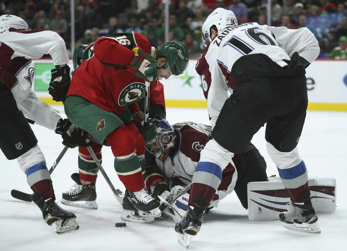 Minnesota Wild left wing Jason Zucker (16) and Colorado Avalanche goalie Jeremy Smith (40) went after a puck well out of the crease in the first period Tuesday night.