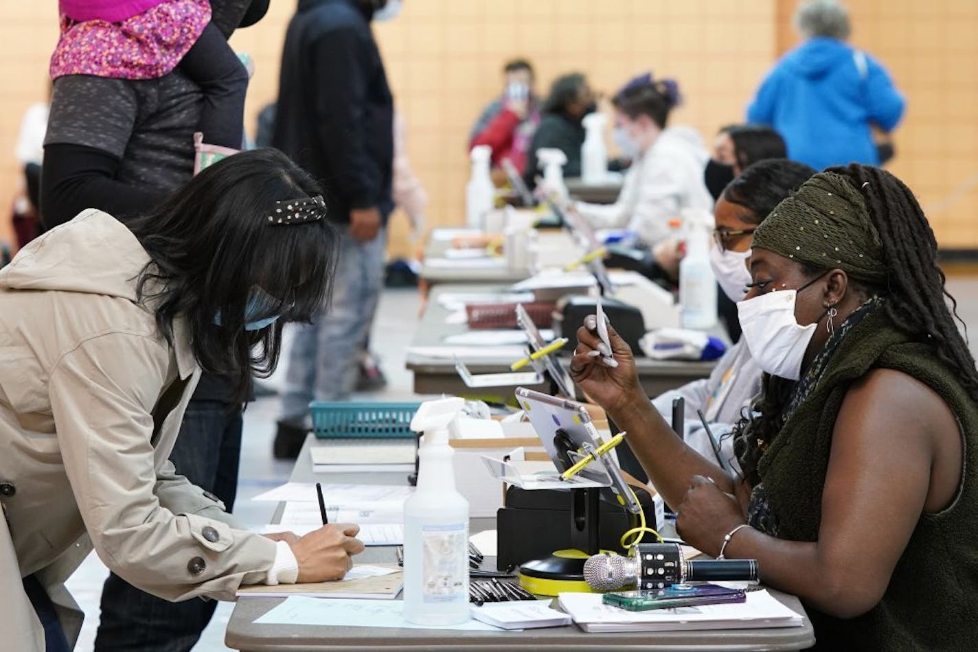 Election judge Orlandia Childs, right, checked in JoeLynn Mulari to vote at the Farview Park Recreation Center polling location in north Minneapolis on Election Day.